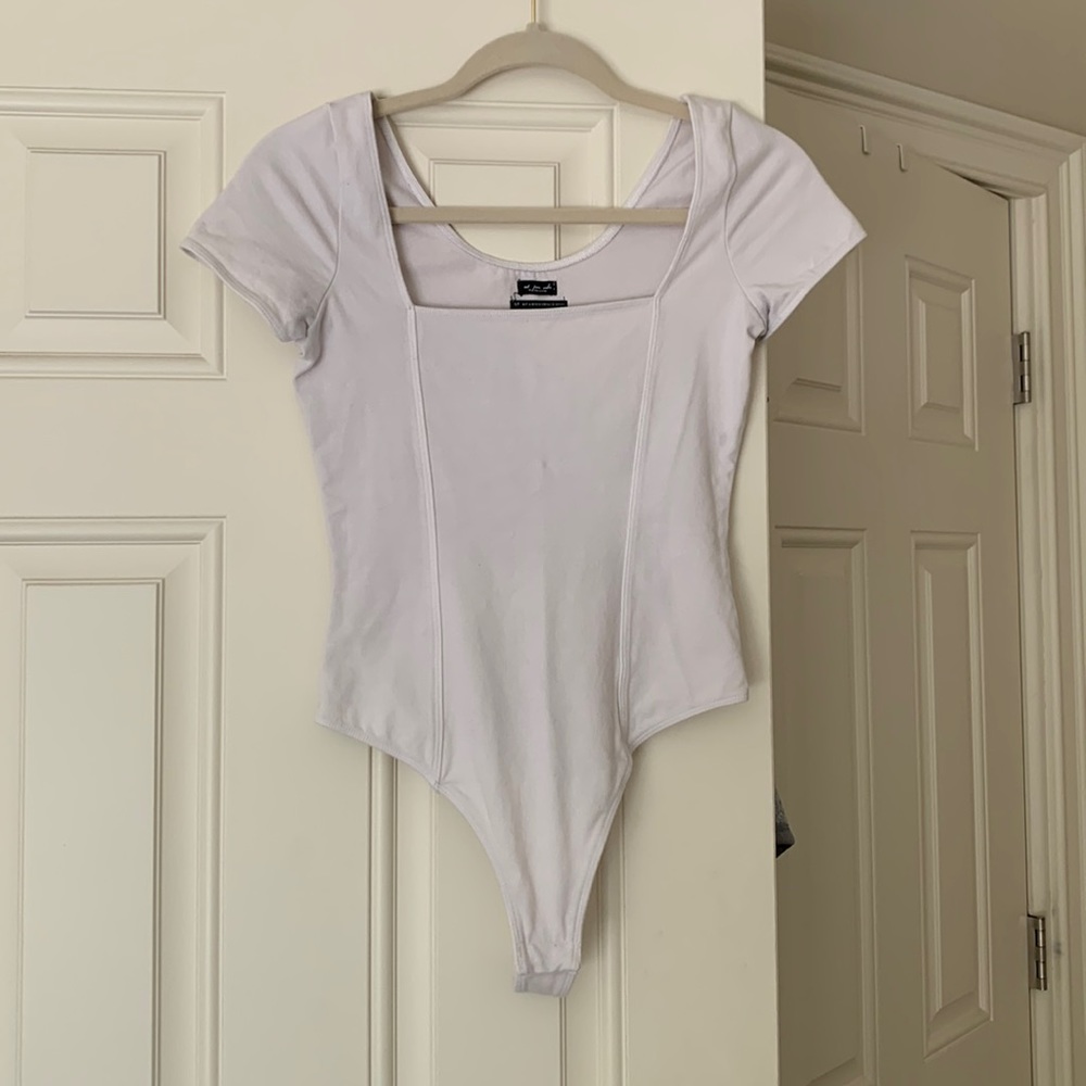 White shirt sleeve UO thong body suit.